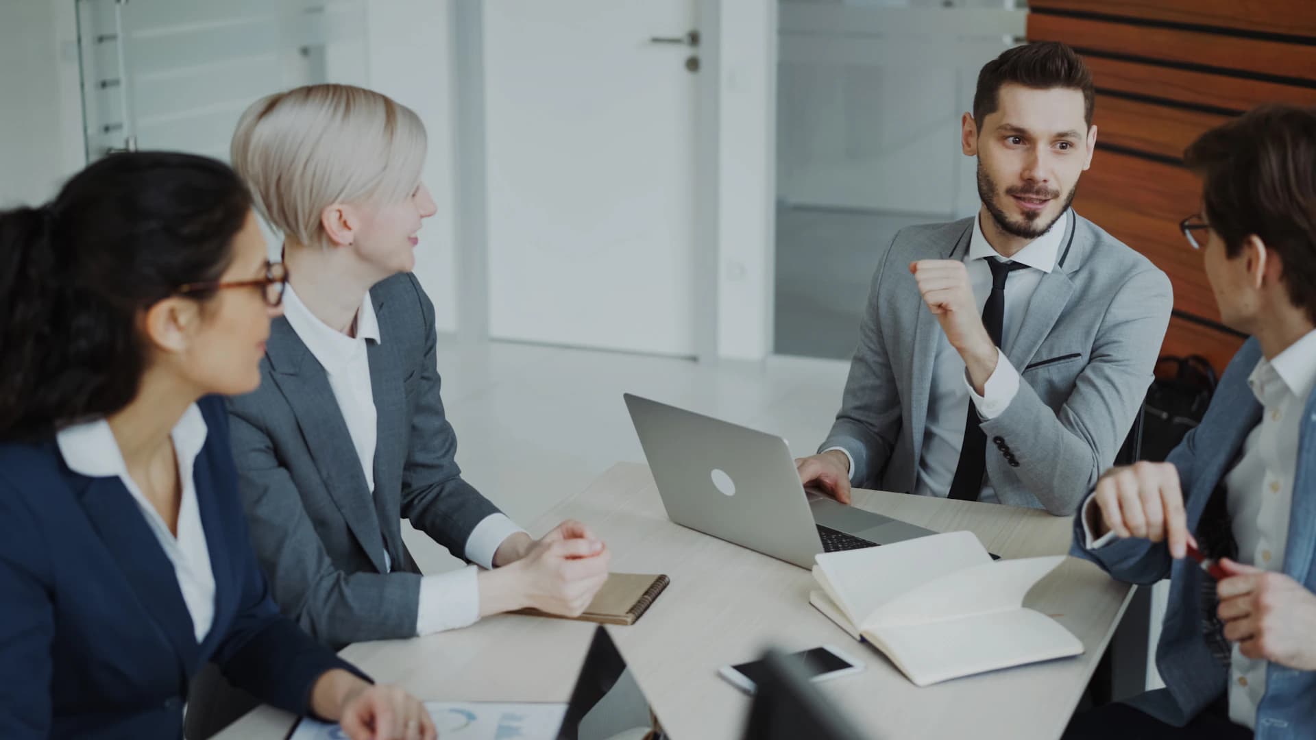 Professionals in a business meeting discussing communication