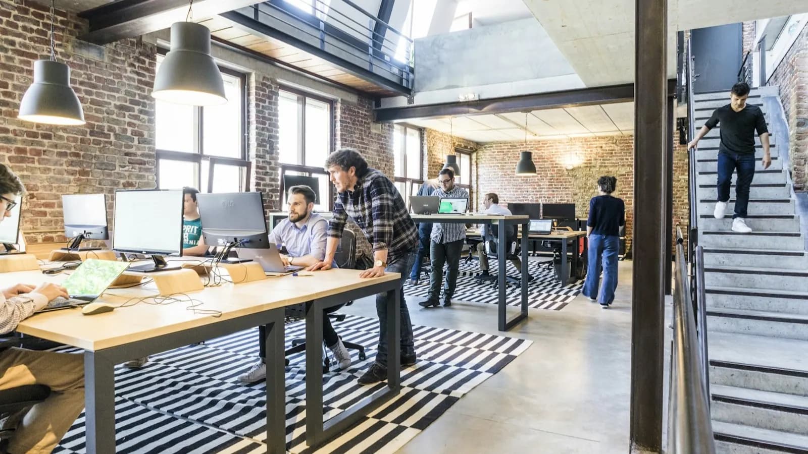 LSCT students working in a modern London coworking space with exposed brick walls