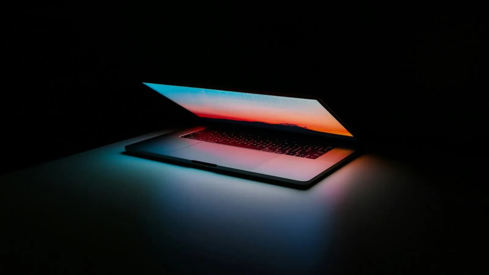 LSCT student's laptop glowing with code in a low-light study setting